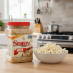 Snappy White Popcorn Kernels 4 lb jar with popped popcorn on kitchen counter