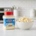 Snappy White Cheddar Popcorn Seasoning in kitchen with popcorn