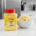 Snappy Butter Popcorn Seasoning on kitchen counter with bowl of popcorn