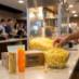 Snappy Snap Packs for 8 oz popcorn machines next to a bowl of popcorn at a theater concession stand