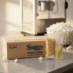 Snappy white popcorn Snap-Paks on counter with an 8 oz popcorn machine and a ball of white popcorn.