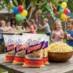 Snappy yellow popcorn being enjoyed outside at a children's birthday party.