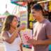 Two people enjoying popcorn from our Red & White Classic Popcorn Tub.