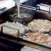 Two-Quart funnel pitcher being used to make funnel cakes in a commercial fryer
