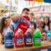 People enjoying Snappy Snow Cone and vendor pouring syrup on a snow cone.