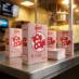 Red and White Striped Closed Top Popcorn Boxes at Theater Concession Stand