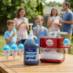 Snappy Blue Raspberry Sno Cone Syrup being used in the background of a party in a single-serve snow cone maker