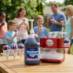 Snappy Grape Sno Cone Syrup being used with a home snow cone machine at a backyard party