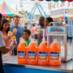 Snappy Orange Sno Cone Syrup being enjoyed at a fair.