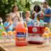 Snappy Orange Sno Cone Syrup being enjoyed at a backyard party