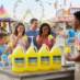 Snappy Banana Sno Cone syrup sno cones being enjoyed by people at a fair
