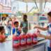 Snappy Tigers Blood Sno Cone syrup sno cones being enjoyed by people at a fair