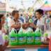 Snappy Green Apple Sno Cone syrup sno cones being enjoyed by people at a fair